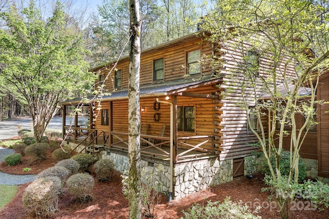 view of property exterior with log siding