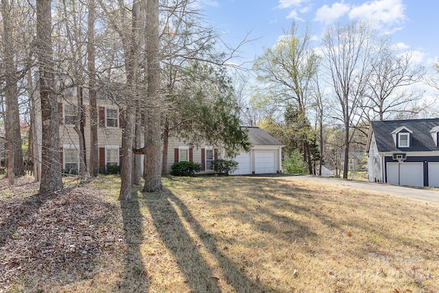 view of front of home featuring a front lawn, a garage, and aphalt driveway