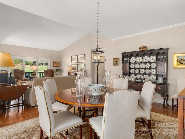 12 Clubside Dr, Asheville, NC 28804 - dining space with vaulted ceiling, ornamental molding, baseboards, a notable chandelier, and wood finished floors
