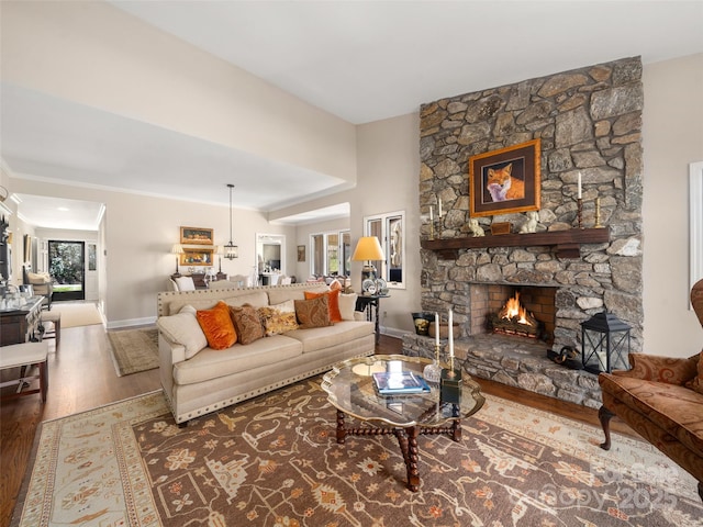 12 Clubside Dr, Asheville, NC 28804 - living room with a stone fireplace, baseboards, and wood finished floors