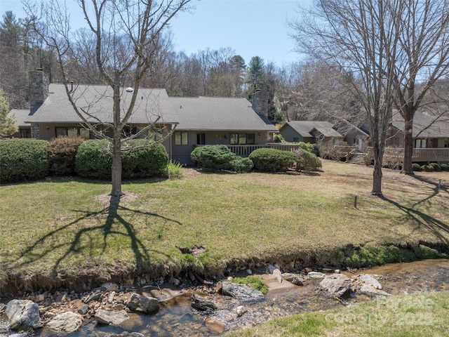 12 Clubside Dr, Asheville, NC 28804 - view of front of home featuring a chimney, a front yard, and a deck
