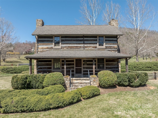 12 Clubside Dr, Asheville, NC 28804 - view of front of property with stone siding, a sunroom, roof with shingles, and a chimney