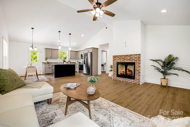 37 Garland Ball Dr, Alexander, NC 28701 - living room featuring ceiling fan, light wood finished floors, recessed lighting, high vaulted ceiling, and a brick fireplace