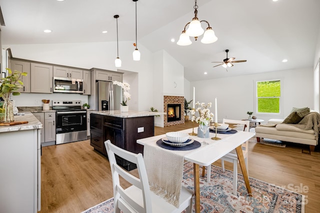 37 Garland Ball Dr, Alexander, NC 28701 - kitchen featuring appliances with stainless steel finishes, open floor plan, gray cabinetry, ceiling fan, and high vaulted ceiling