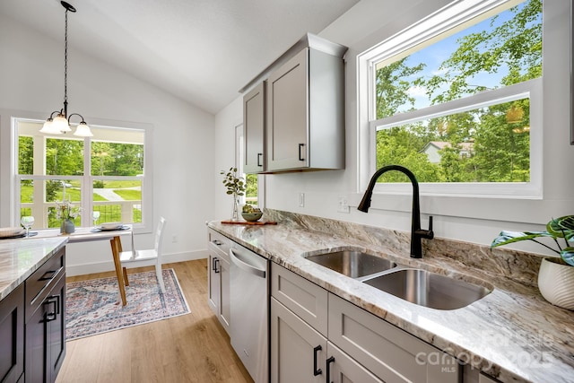 37 Garland Ball Dr, Alexander, NC 28701 - kitchen with stainless steel dishwasher, a sink, vaulted ceiling, light wood-style flooring, and decorative light fixtures