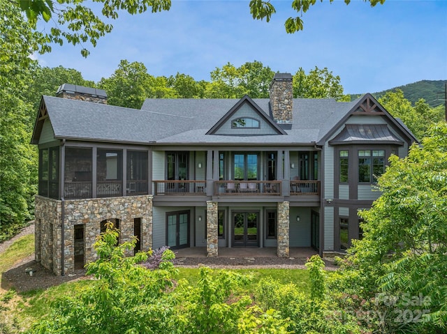 45 Fates Overlook Loop, Black Mountain, NC 28711 - back of property featuring french doors, a chimney, stone siding, a shingled roof, and a patio