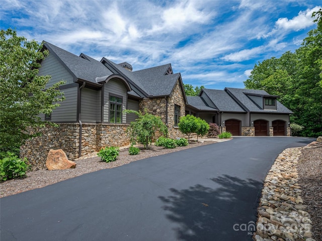 45 Fates Overlook Loop, Black Mountain, NC 28711 - view of front of house featuring stone siding, driveway, a shingled roof, and a garage