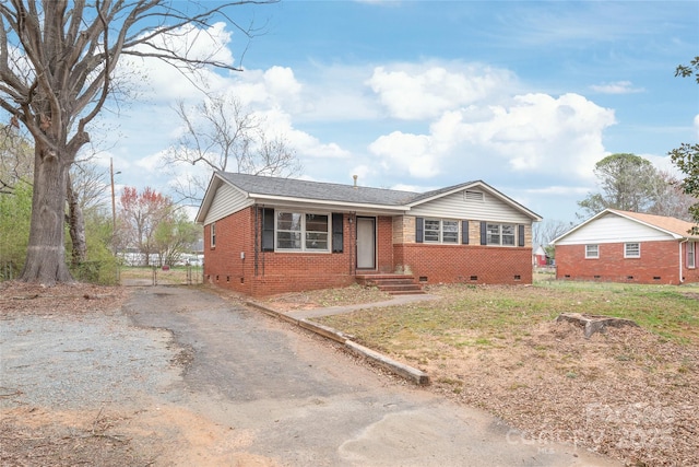 ranch-style house featuring driveway, crawl space, and brick siding
