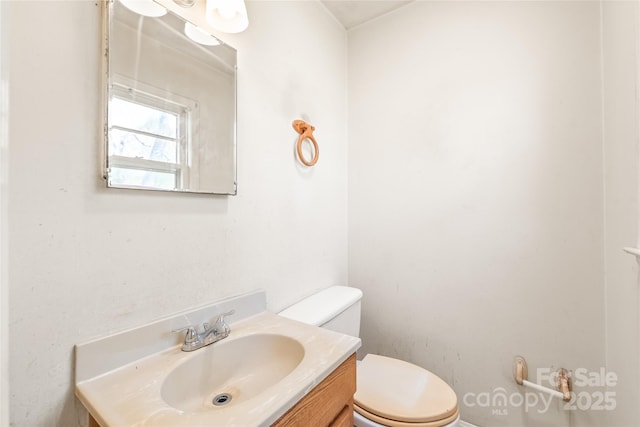 half bathroom with toilet and vanity