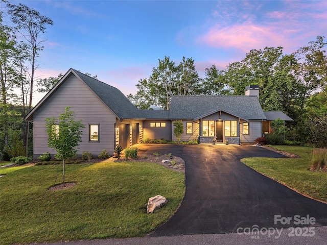 162 Riverbend Forest Dr, Asheville, NC 28805 - view of front of house featuring a shingled roof, a chimney, a front yard, and aphalt driveway