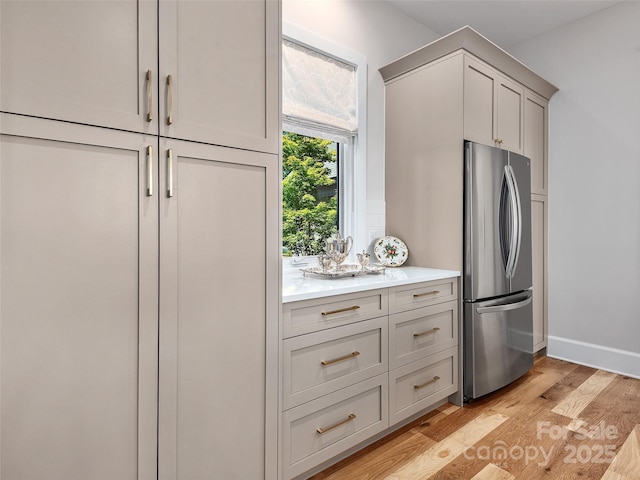 162 Riverbend Forest Dr, Asheville, NC 28805 - kitchen featuring light countertops, light wood finished floors, baseboards, gray cabinets, and freestanding refrigerator
