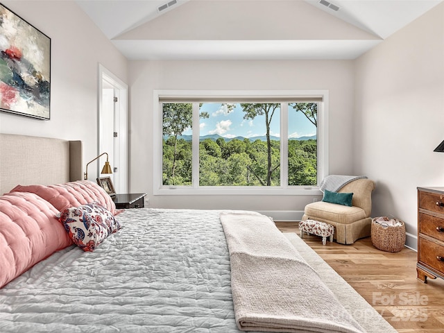 162 Riverbend Forest Dr, Asheville, NC 28805 - bedroom featuring baseboards, vaulted ceiling, visible vents, and wood finished floors