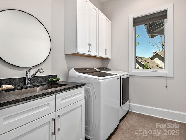 162 Riverbend Forest Dr, Asheville, NC 28805 - washroom featuring dark tile patterned floors, baseboards, a sink, cabinet space, and washer and dryer