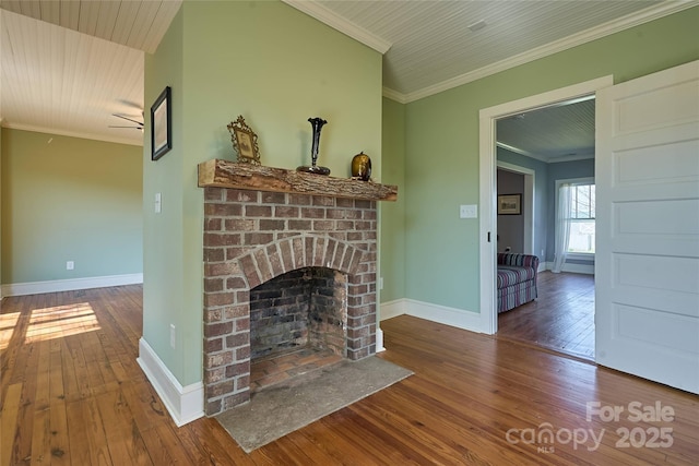 570 Lambs Grill Rd, Rutherfordton, NC 28139 - unfurnished living room featuring baseboards, a fireplace, ornamental molding, and wood-type flooring