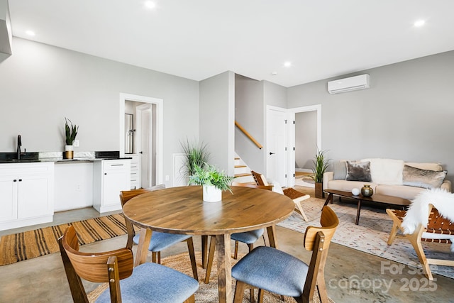 dining area with a wall mounted air conditioner, recessed lighting, stairway, and finished concrete floors