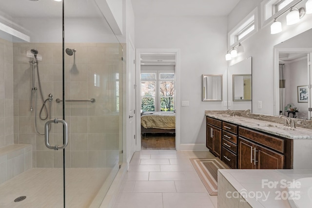 full bath featuring tile patterned floors, a sink, a stall shower, and ensuite bathroom