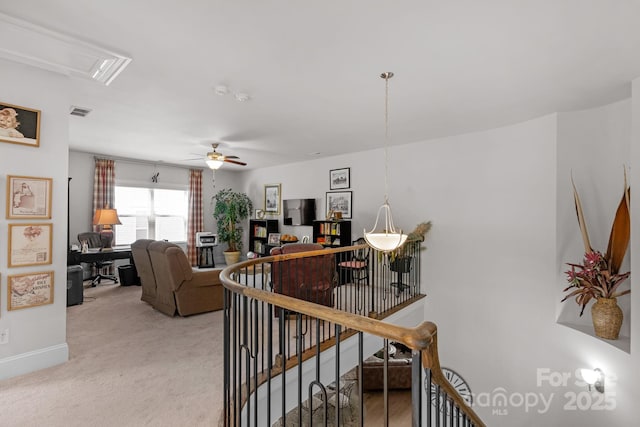 stairway with visible vents, carpet, baseboards, a ceiling fan, and attic access