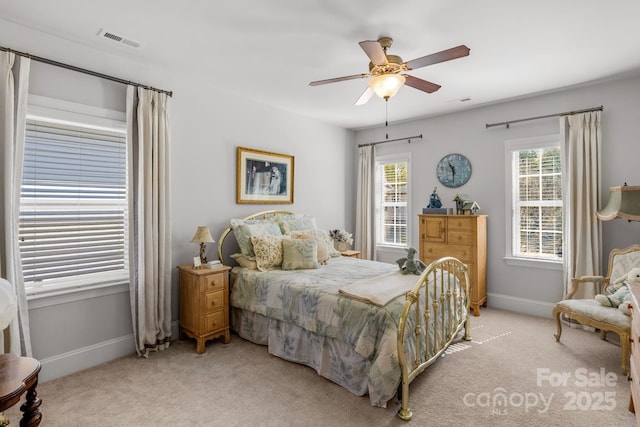 bedroom with a ceiling fan, light carpet, baseboards, and visible vents