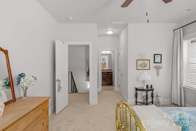 bedroom with light colored carpet, baseboards, ensuite bath, ceiling fan, and visible vents