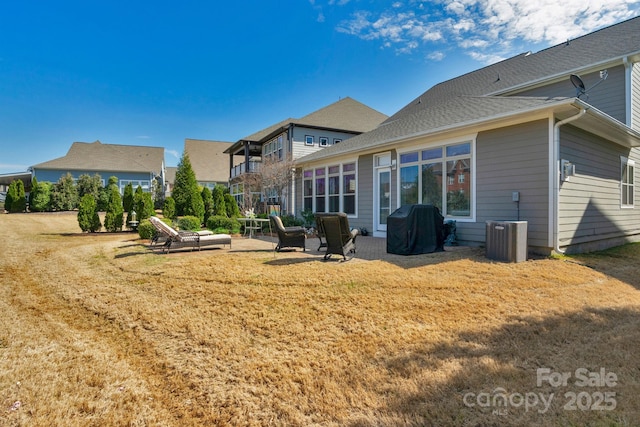 back of property featuring a patio, central AC, and a lawn