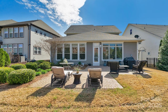 back of property featuring a patio, fence, and a yard
