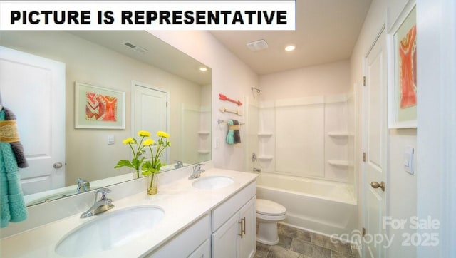 full bath featuring toilet, double vanity, a sink, and bathtub / shower combination