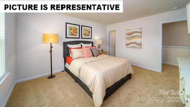 bedroom with light colored carpet and baseboards