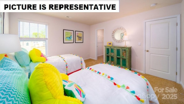 carpeted bedroom featuring baseboards