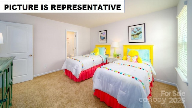 carpeted bedroom with baseboards and ensuite bath