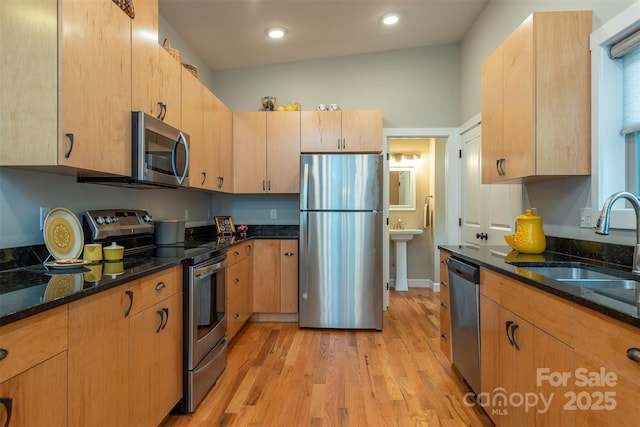 102 Kanawha Dr, Montreat, NC 28757 - kitchen with dark stone counters, stainless steel appliances, a sink, and light wood-style floors