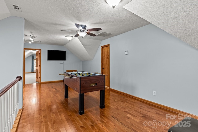 7146 Sifford Rd, Stanley, NC 28164 - rec room featuring ceiling fan, lofted ceiling, light wood-style floors, a textured ceiling, and baseboards