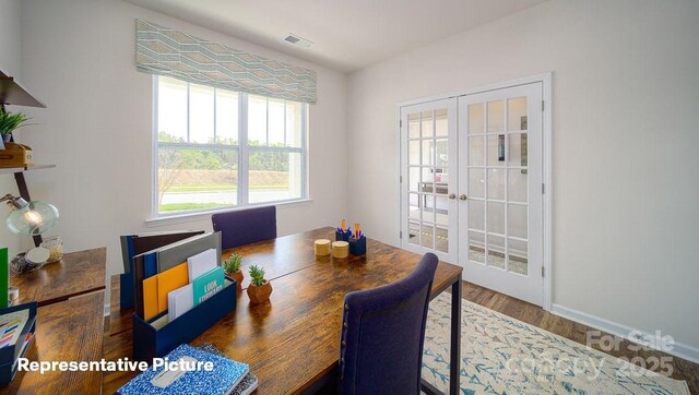 dining room featuring baseboards, visible vents, french doors, and wood finished floors