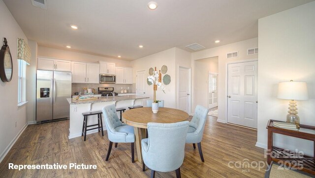 dining area with visible vents, recessed lighting, and dark wood-style floors