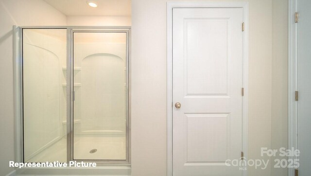bathroom featuring a shower stall and recessed lighting