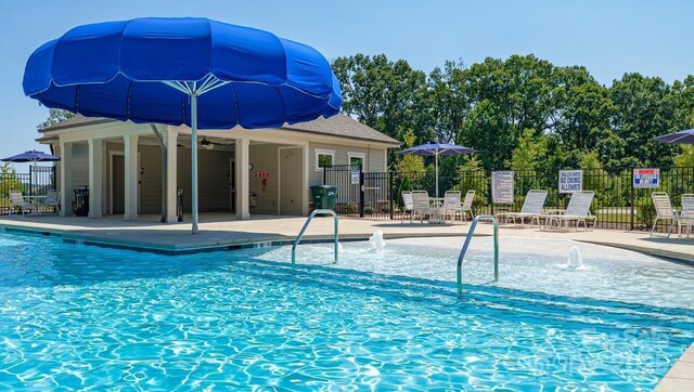 pool featuring a patio area and fence