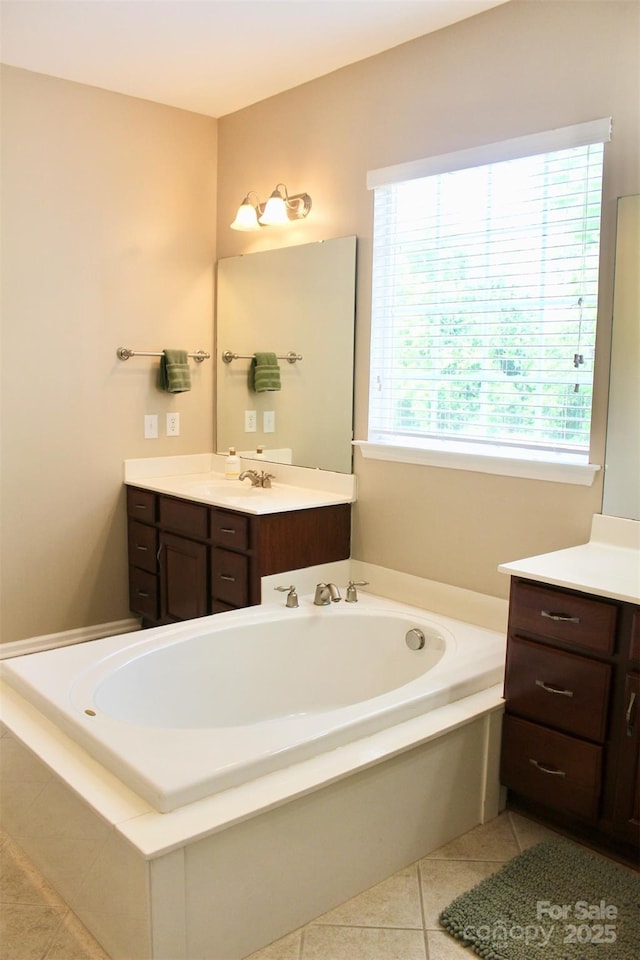 bathroom featuring tile patterned floors, vanity, and a bath