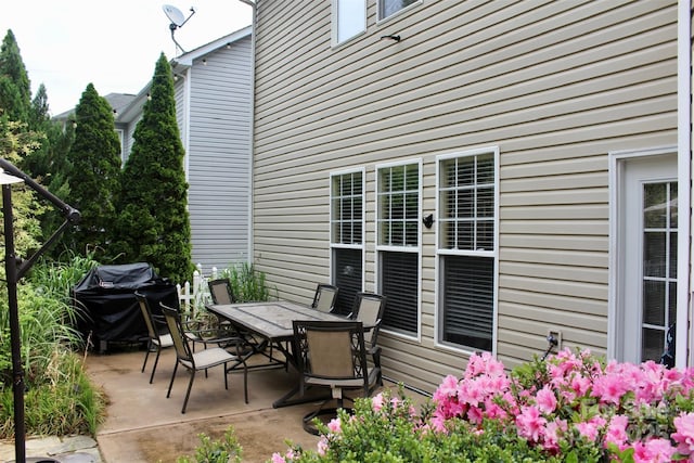 view of patio with outdoor dining space and grilling area