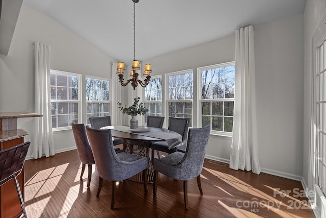 dining space with dark wood-type flooring, an inviting chandelier, baseboards, and visible vents