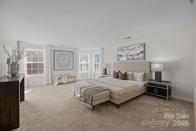 bedroom featuring visible vents, carpet flooring, and baseboards