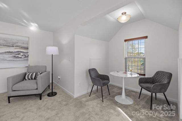 living area featuring lofted ceiling, carpet floors, and baseboards