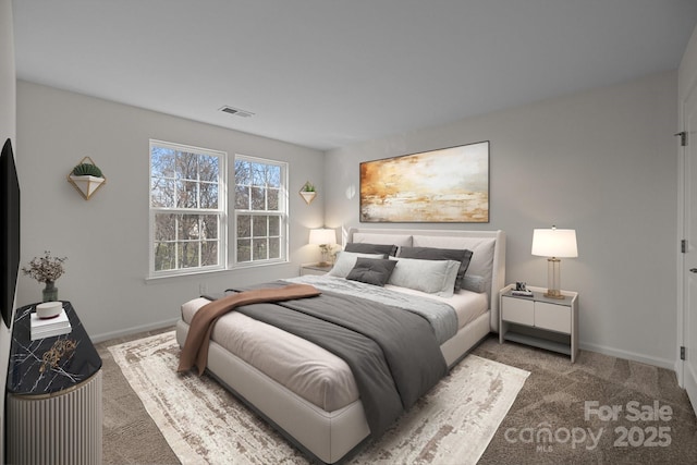 carpeted bedroom featuring baseboards and visible vents