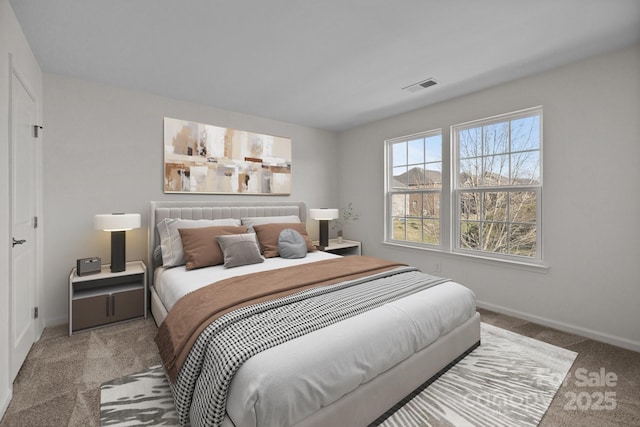carpeted bedroom with visible vents and baseboards