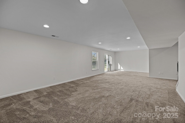 interior space featuring baseboards, visible vents, carpet, and recessed lighting