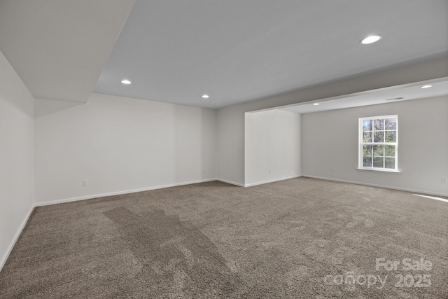 empty room featuring recessed lighting, carpet flooring, and baseboards