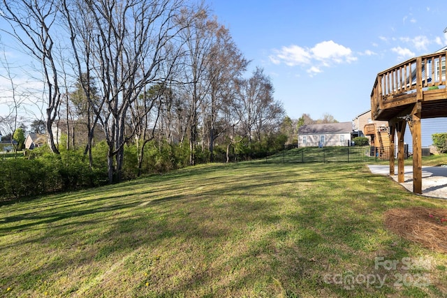 view of yard featuring fence and a wooden deck