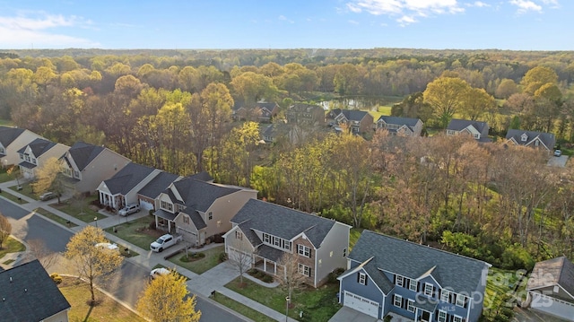 bird's eye view featuring a wooded view and a residential view