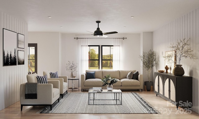 living area featuring light wood-style flooring and a ceiling fan