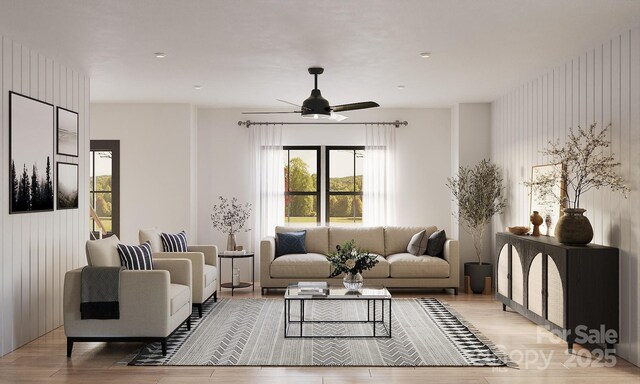 living room with ceiling fan and light wood-type flooring