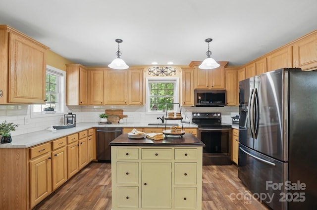 9711 Pine Tree Rd, Norwood, NC 28128 - kitchen with a kitchen island, wood finished floors, decorative backsplash, and stainless steel appliances
