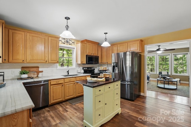 9711 Pine Tree Rd, Norwood, NC 28128 - kitchen featuring a sink, backsplash, black appliances, and dark wood-style flooring